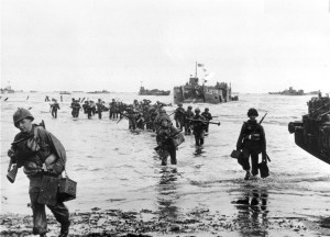 American assault troops move onto a beachhead during the D-Day invasion of German-occupied France on the beach of Normandy, June 7, 1944  during World War II.  The harbor is filled with numerous other landing craft awaiting orders.  (AP Photo)